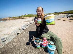 Picture by Luke Le Prevost. 25-05-23..Guernsey Dairy has unveiled their new packaging for their ice-cream. Izzy Millis from L'Ancresse Kiosk holding the Vanilla flavour which design includes the L'Ancresse tower behind.. (32152860)