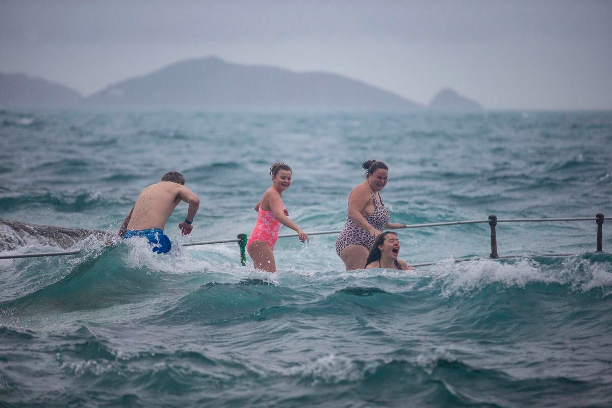 Emily Malcolm, 15, takes the plunge while Abi Mallett, 12 and Lucy Mallett look on. (Pictures by Peter Frankland, 30344866)