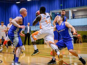 Pic supplied by Andrew Le Poidevin: 13-01-2023...Division One Basketball at Beau Sejour. Edmundson Electrical Chargers v Le Mont Saint. Shek Sesay bursts through between Dan Marriott, left, and Ashly Ward. (31680577)