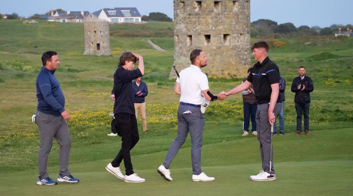 Steve Mahy shakes the hand of Rory McKenna, far right, at the end of the final on the 16th green. (32087252)