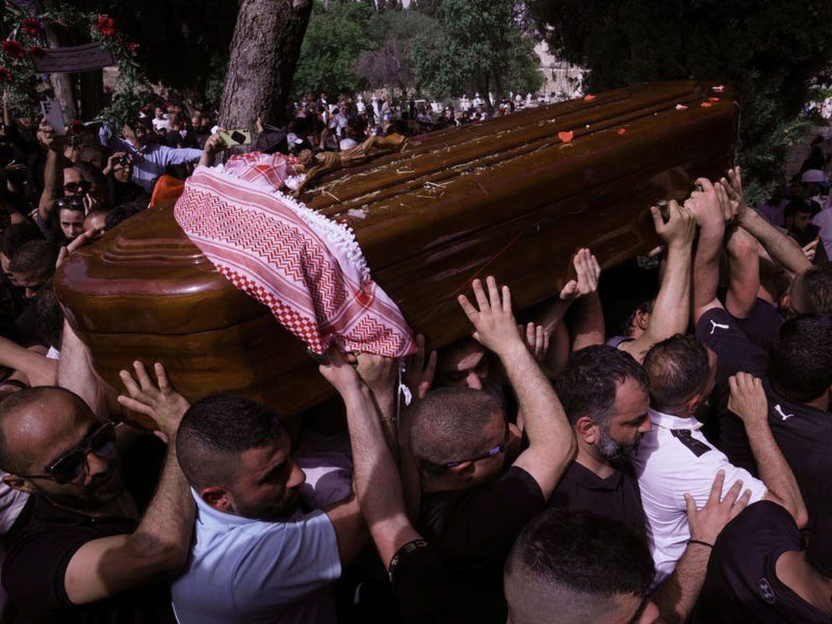 Pallbearers drop journalist’s coffin as Israeli police hit mourners with batons