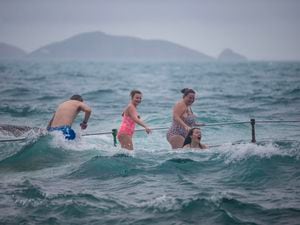 Emily Malcolm, 15, takes the plunge while Abi Mallett, 12 and Lucy Mallett look on. (Pictures by Peter Frankland, 30344866)