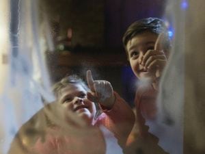 View through glass of laughing children looking at stars. (Shutterstock picture) (29221213)