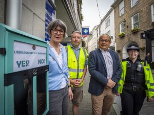 Left to right: St Peter Port douzenier Odette Duerden, Anthony Court from Traffic and Highway Services, Deputy Chris Blin and PC 60 Ellora Koulcoutas next to Guernsey's first cigarette 'ballot' bin outside Boots in Town.  (Picture by Sophie Rabey, 30802668)