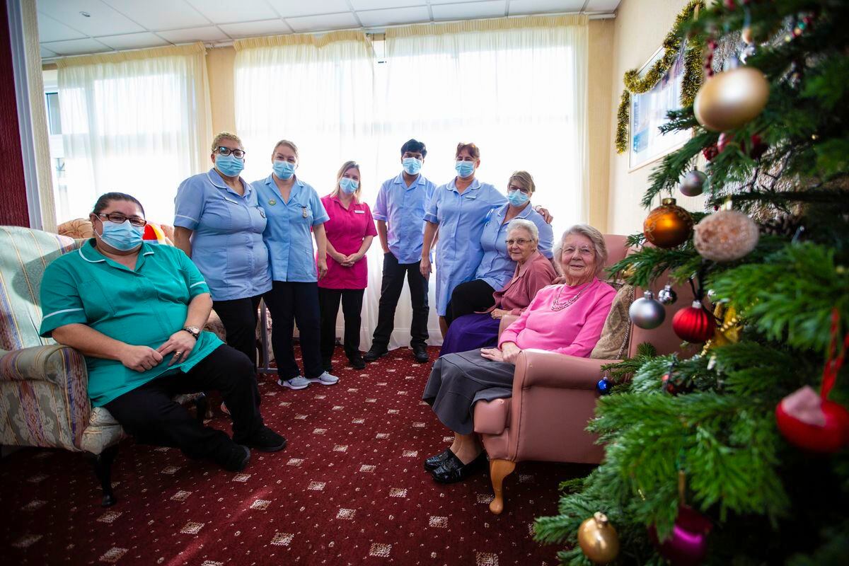 Summerland House Care Home staff who are working over the Christmas period. Left to right: Elsa Pereia, Betty Abreu, Elsa Dunne, Sarah Ross, Husain Ahmed, Matilda De Jesus and Lyndsey Nicholls with residents Margaret Norledge and Mona Falla. (Picture by Peter Frankland, 30322901)