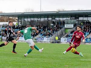 Pic supplied by Andrew Le Poidevin: 13-03-2022..Guernsey Football Club v Hanwell Town at Footes Lane in the Isthmian South Central League. Kieran Mahon scored the opening goal of the game through the legs of Hanwell Town goalkeeper Hugo Sobte. (30600290)