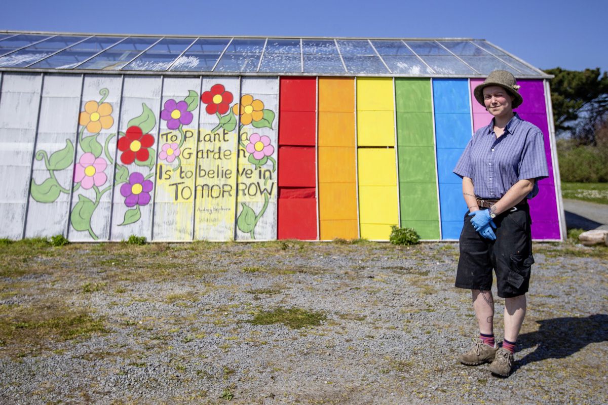Jenny Harding with a rainbow greenhouse and a quote from Audrey Hepburn at La Rue des Reines, Forest.