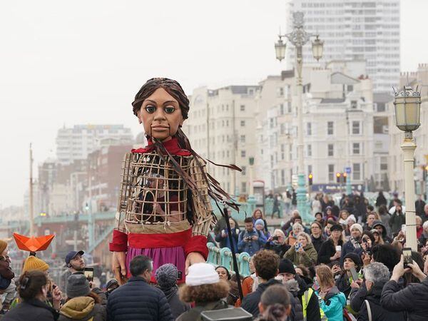 Giant puppet Little Amal leads walk in Brighton to raise awareness of refugees