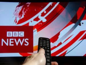 Soest, Germany - January 14, 2018: Man watching BBC News on TV. BBC News is an operational business division of the British Broadcasting Corporation (BBC). (29610883)
