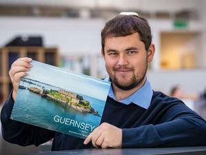 Picture by Sophie Rabey.  18-11-22.  Guernsey Press Photographer Luke Le Prevost with the GP 2023 Calandar that comes out next week.. (31486588)