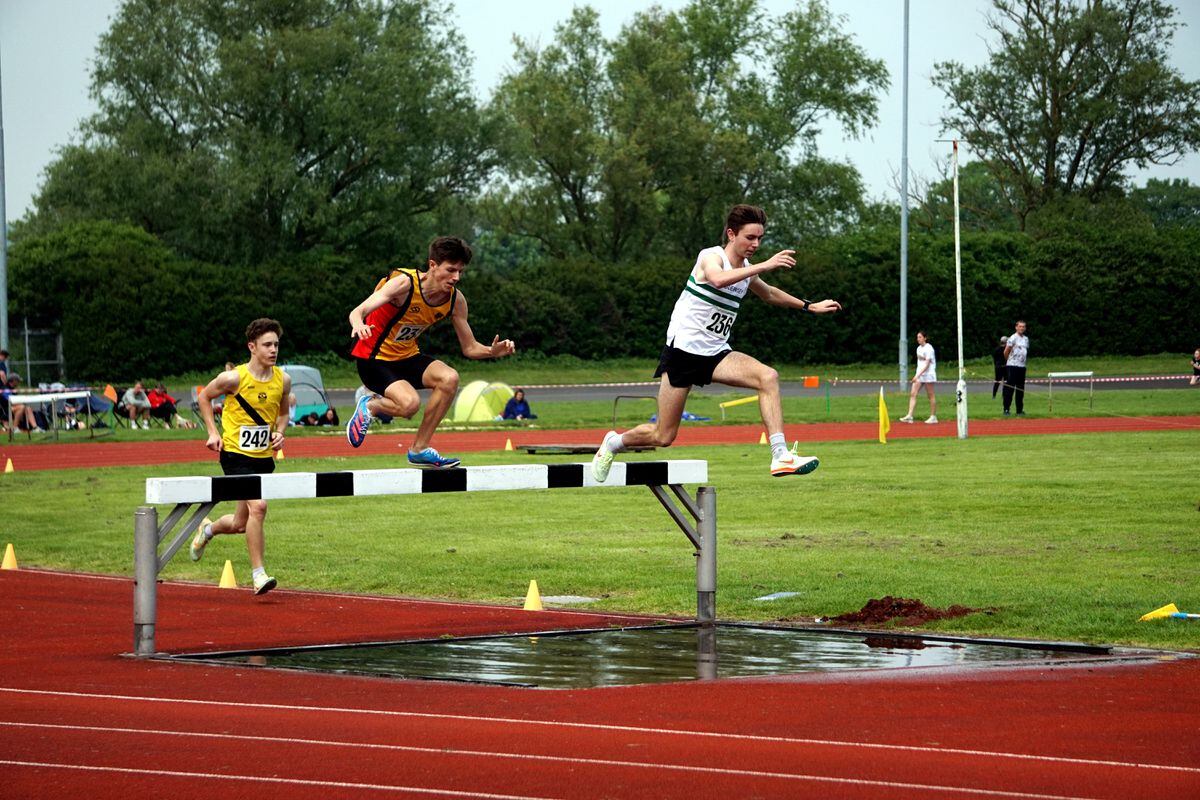 Jack Le Tissier leads the U20 steeplechasers over the water jump. (Picture by Jamie Ingrouille, 32118604)
