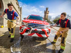 Firefighters Tristan Queripel, left, and Alex Clark get in some practice on of their vehicles before tomorrow’s charity car wash.  (Picture by Sophie Rabey, 31962793)