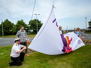 The Platinum Jubilee Flag for Guernsey, designed by competition winner Ben Le Marchant, was hoisted on the Weighbridge roundabout, with Sea Cadets commanding officer Lt Tony Browning lending his expertise. (Pictures by Luke Le Prevost, 30847504)
