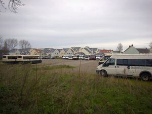 Buses and commercial vehicles parked on the former Bouet Estate site. Pitronnerie Road. (30371755)